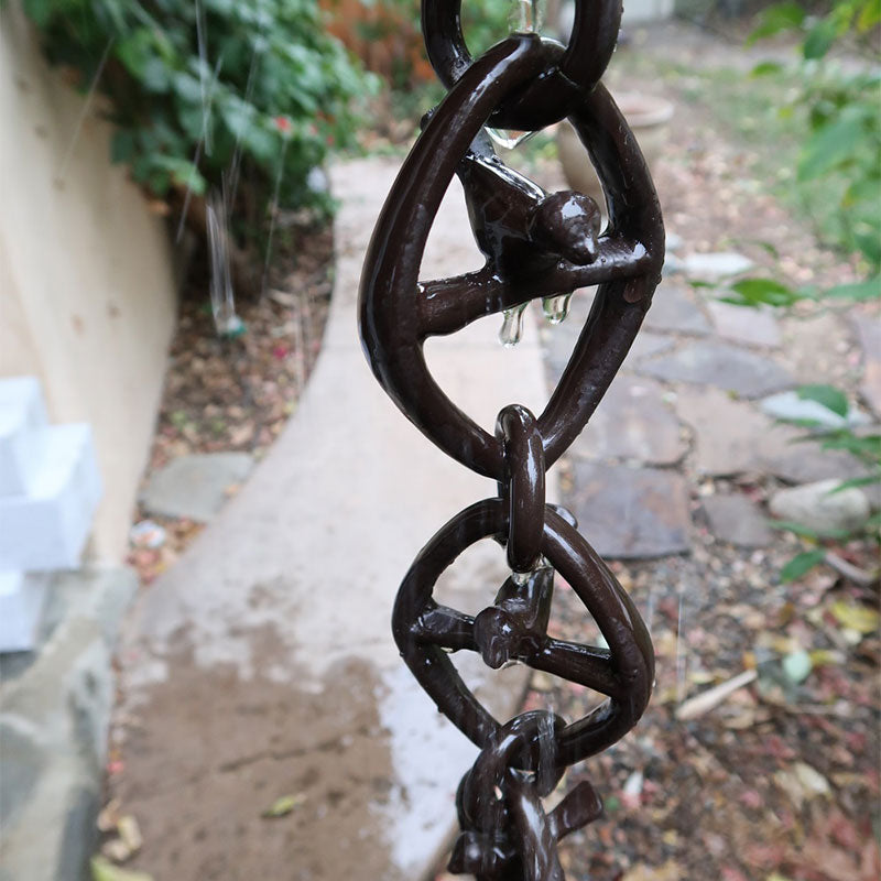 Bird on a Wire Link Rain Chain in Bronze with water flowing through it