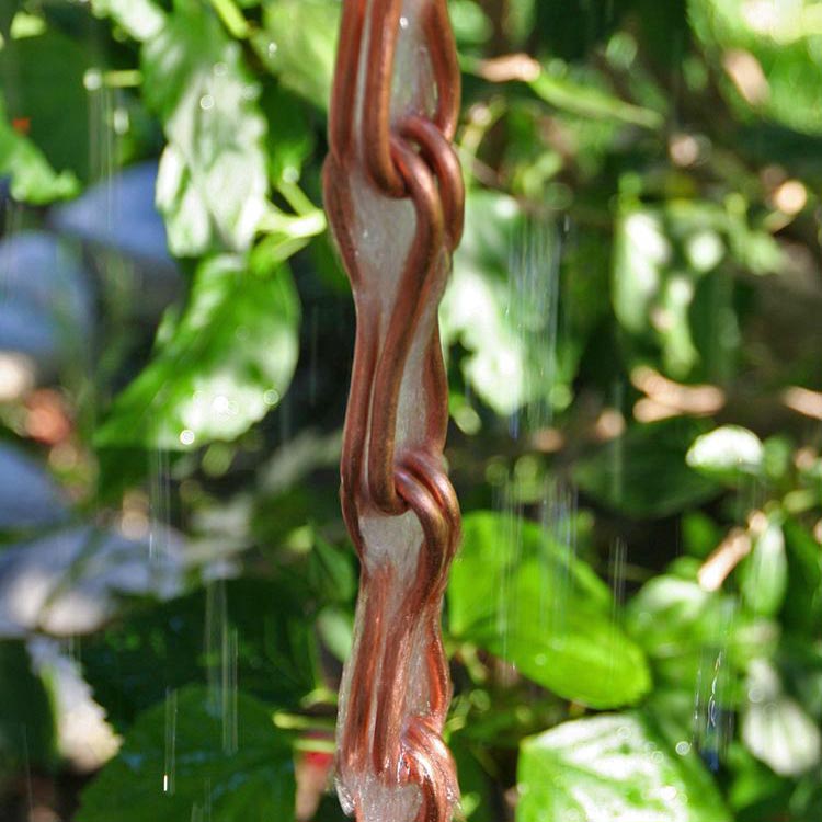 Infinity Link Copper Rain Chain with water running through it